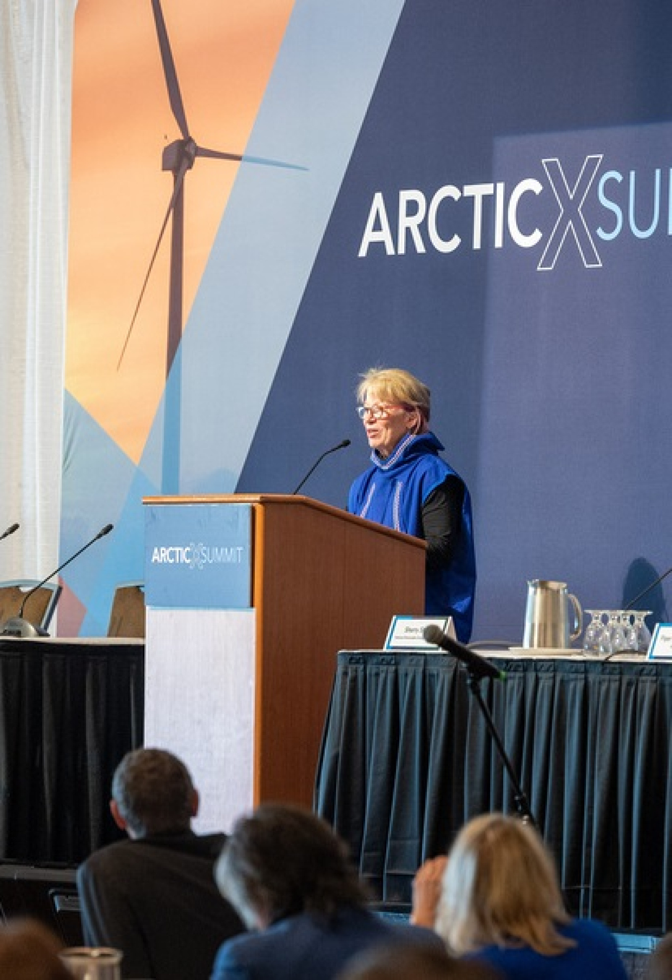 Dr. Richmond speaks at the podium at ArcticX.