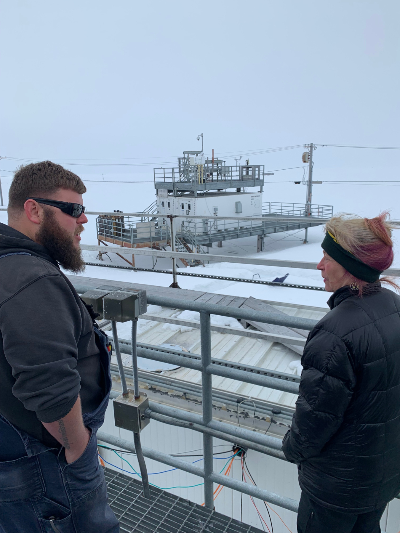 A scientist and Dr. Richmond discuss the ARM facility in Utiqiakgvik.