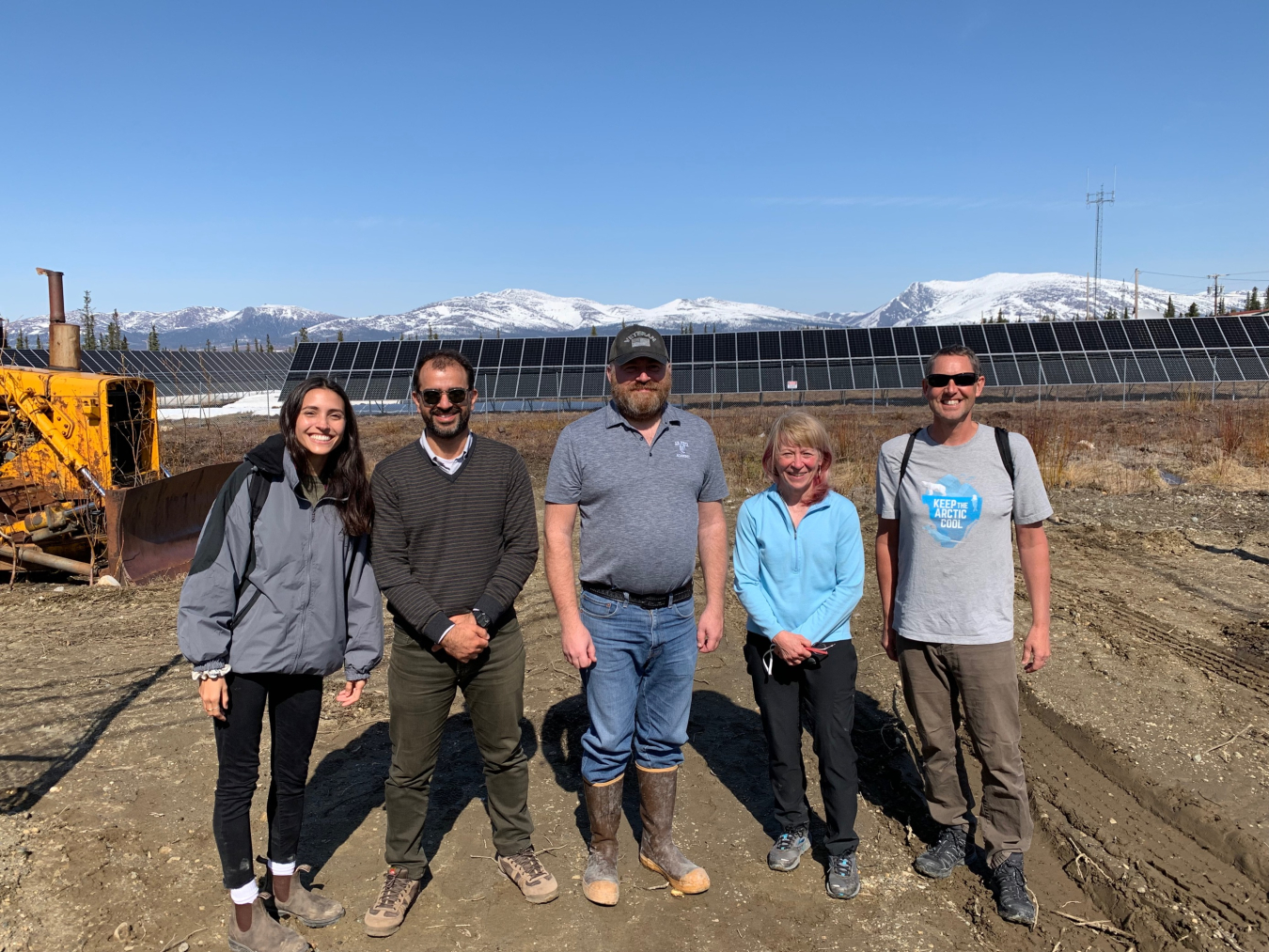 Dr. Richmond and colleagues stand in front of solar panels in Shungnak.