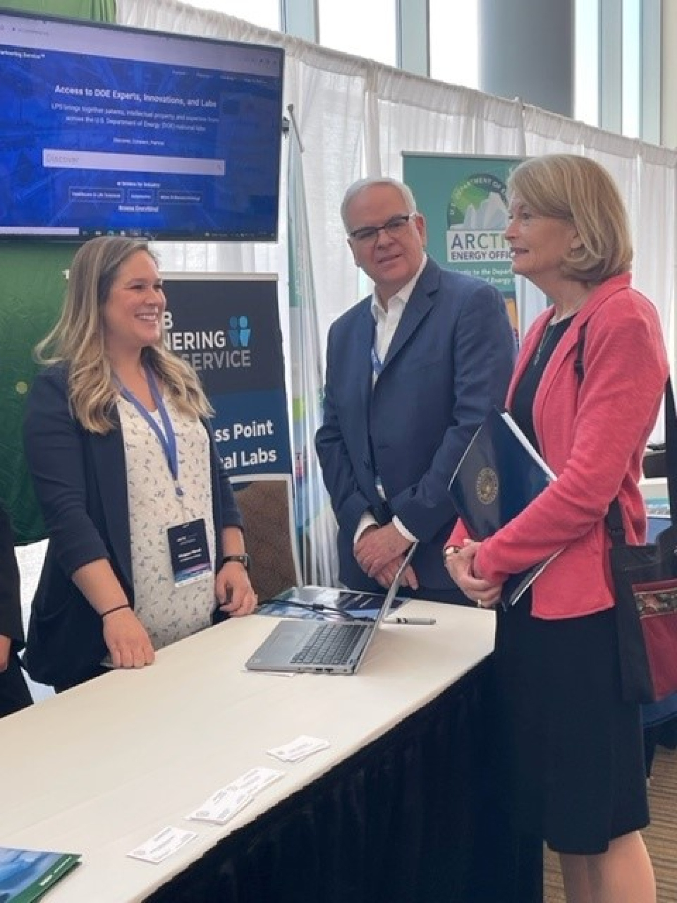 Margaux Murali and Jim Fritz speak with Sen. Lisa Murkowski at the OTT booth at ArcticX.