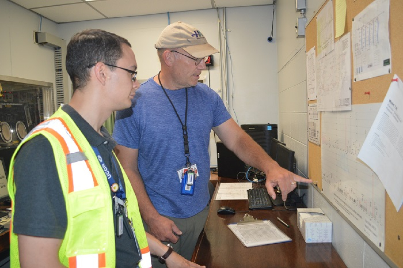 UCOR intern Ronald Randazzo, left, verifies information in his role on the UCOR conduct of operations team. He is pictured with Brent Henderson, facility manager at the Molten Salt Reactor Experiment at Oak Ridge.