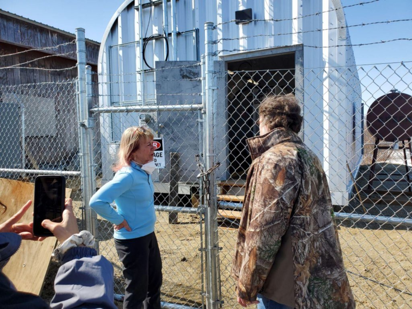Dr. Richmond talks to a Shungnak energy representative about the battery storage facility at Shungnak.