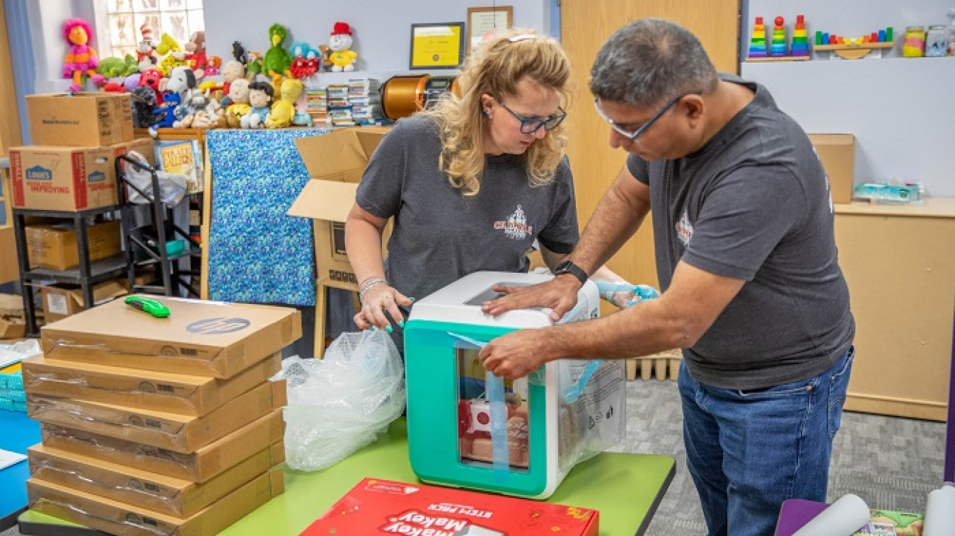 Nuclear Waste Partnership employees Nichole Lundgard and Khushroo Ghadiali set up lab equipment for the grand opening of a Cal Ripken, Sr. Foundation STEM center at the Carlsbad Public Library in Carlsbad, New Mexico.