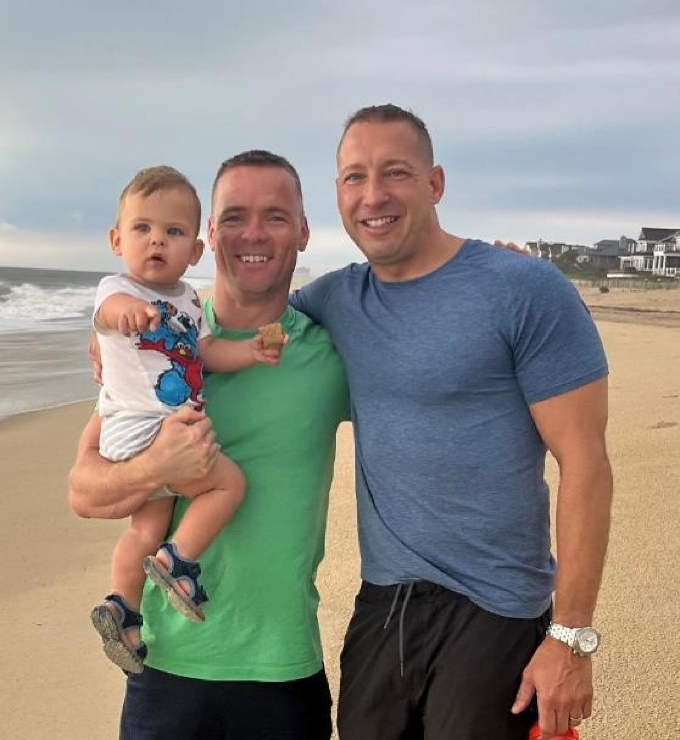Jason with his husband and son at the beach