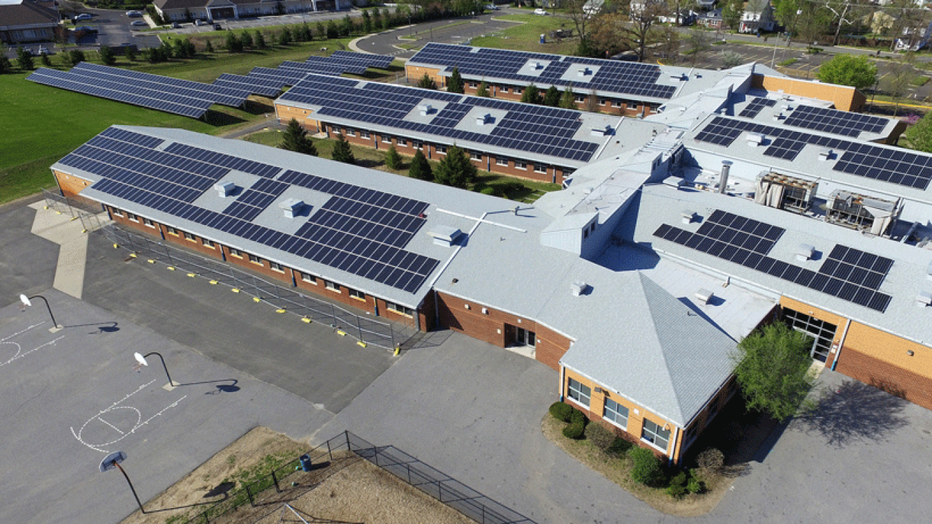 Photo of a land and building solar installation on a school in Delran, New Jersey. 