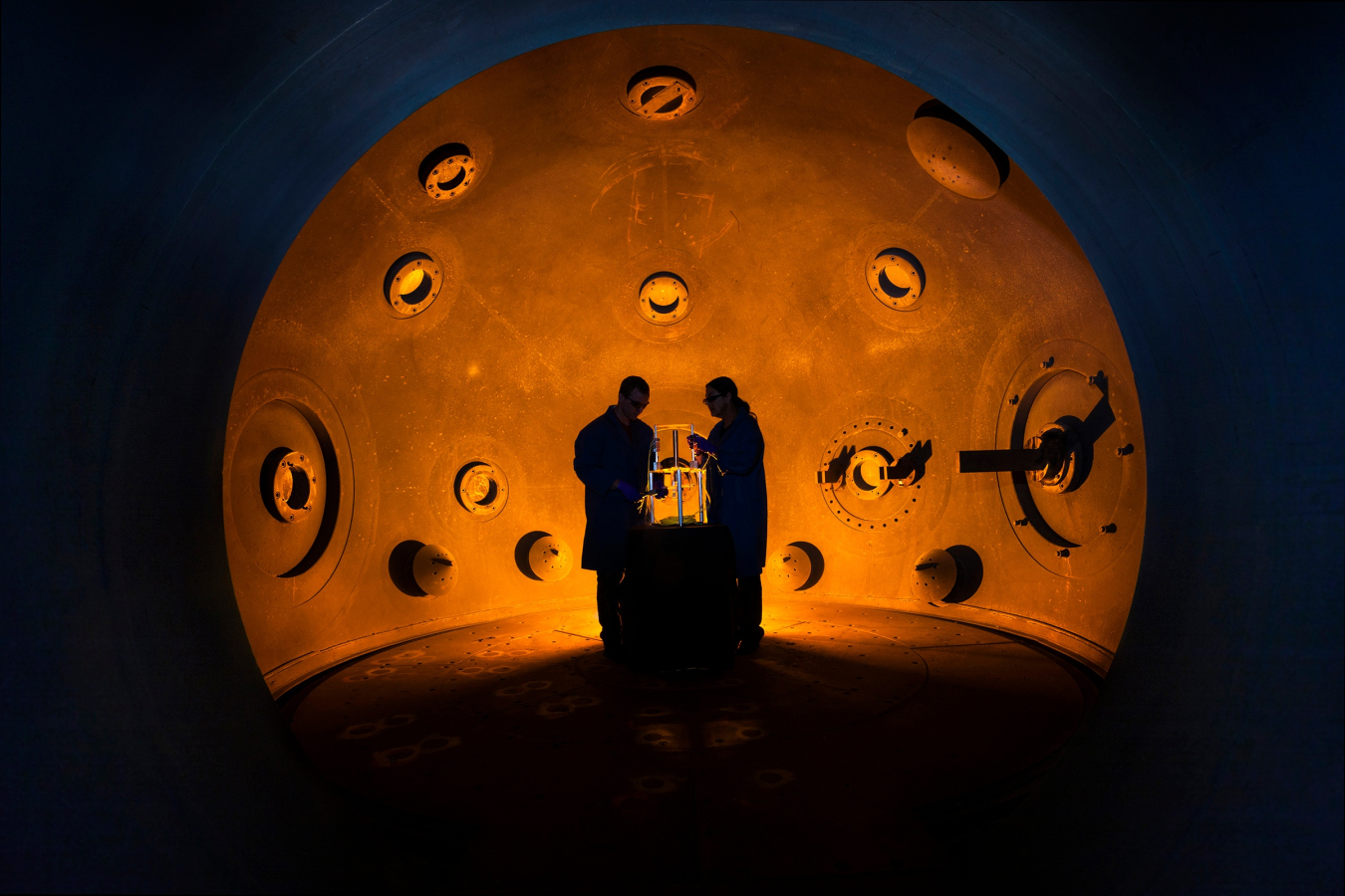 Scientists in the Lawrence Livermore National Lab standing at the high explosives application facility tank