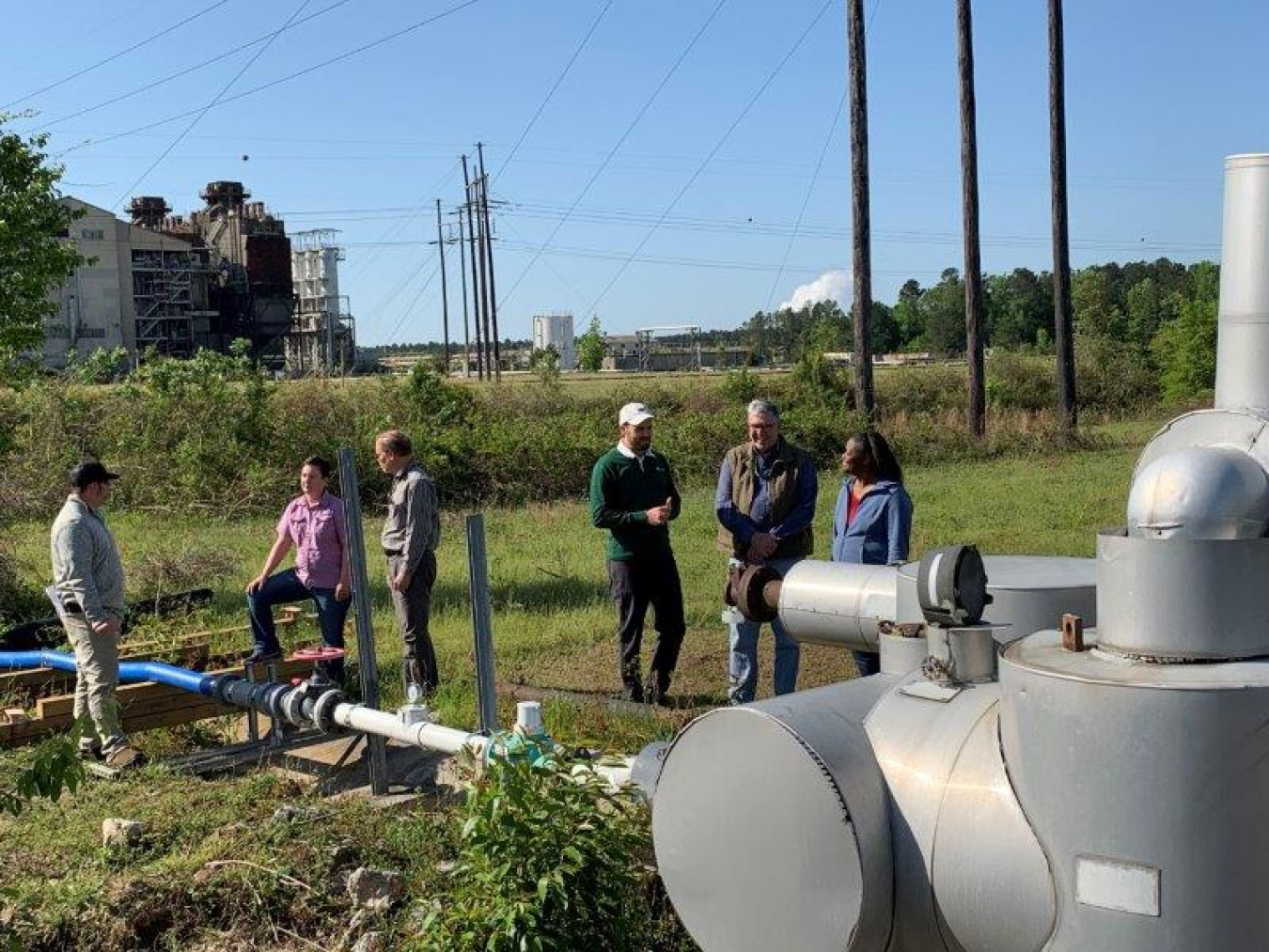 Savannah River Nuclear Solutions (SRNS) Technicians confers with Brian Hennessey and Karen Morrow, right, of DOE's Infrastructure & Area Completion Division at the D Area site.