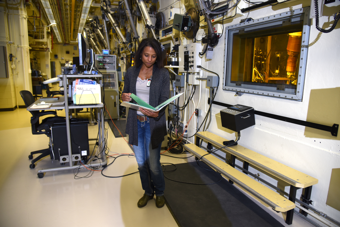 A scientist looks at their notebook in a laboratory 