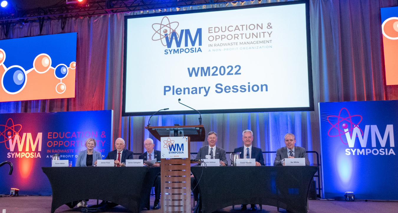 Six people at the plenary speakers table