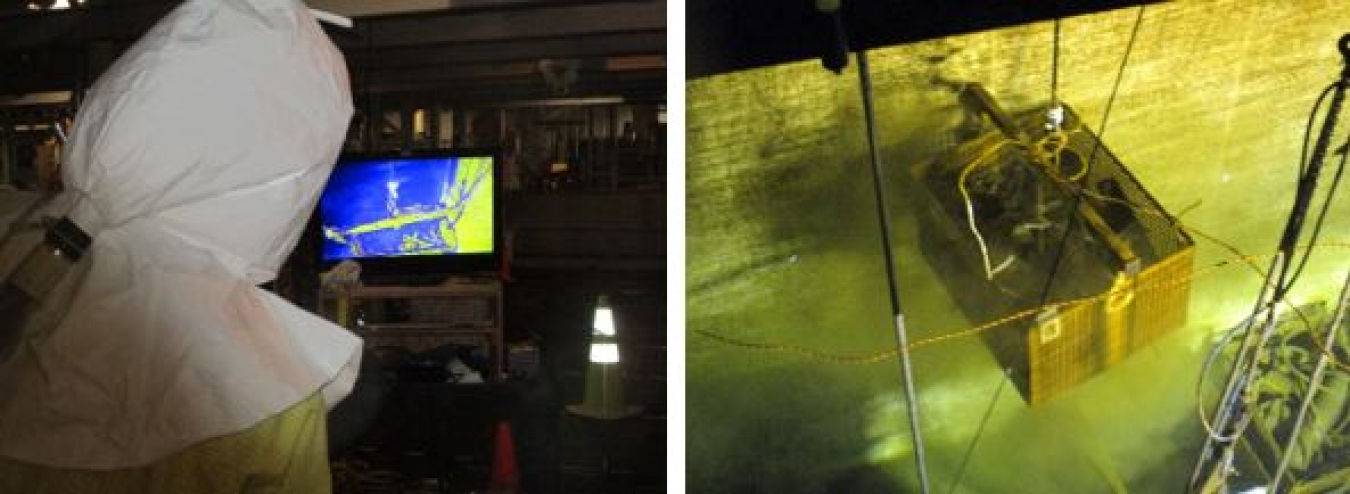 Workers use underwater cameras as they move sorting bins for washing prior to placing debris in vertical steel tubes, which will be filled with grout and removed during demolition of the grout-filled basin. Debris removal and stabilization is the latest step in the Hanford Site’s multiphase demolition of the reactor’s basin.