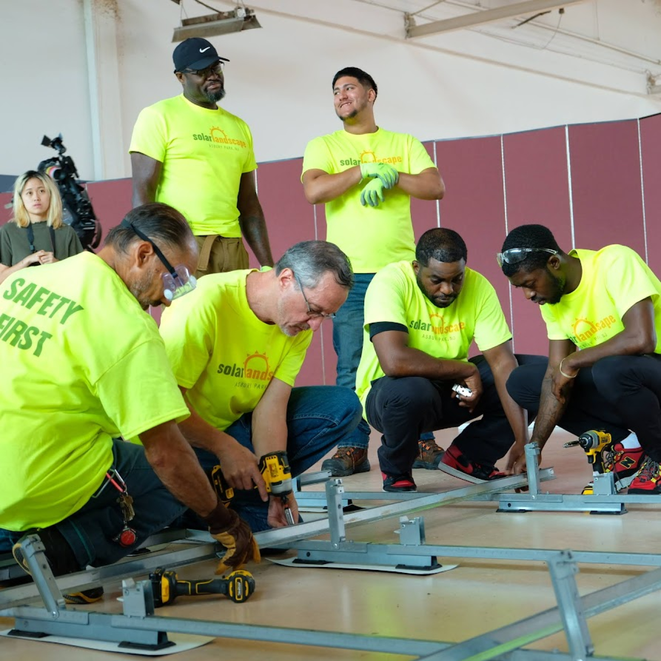 Photo of several people installing solar panels