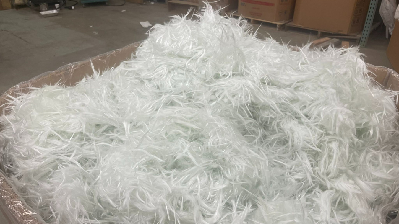 A large amount of recycled glass fiber placed in a cardboard box.