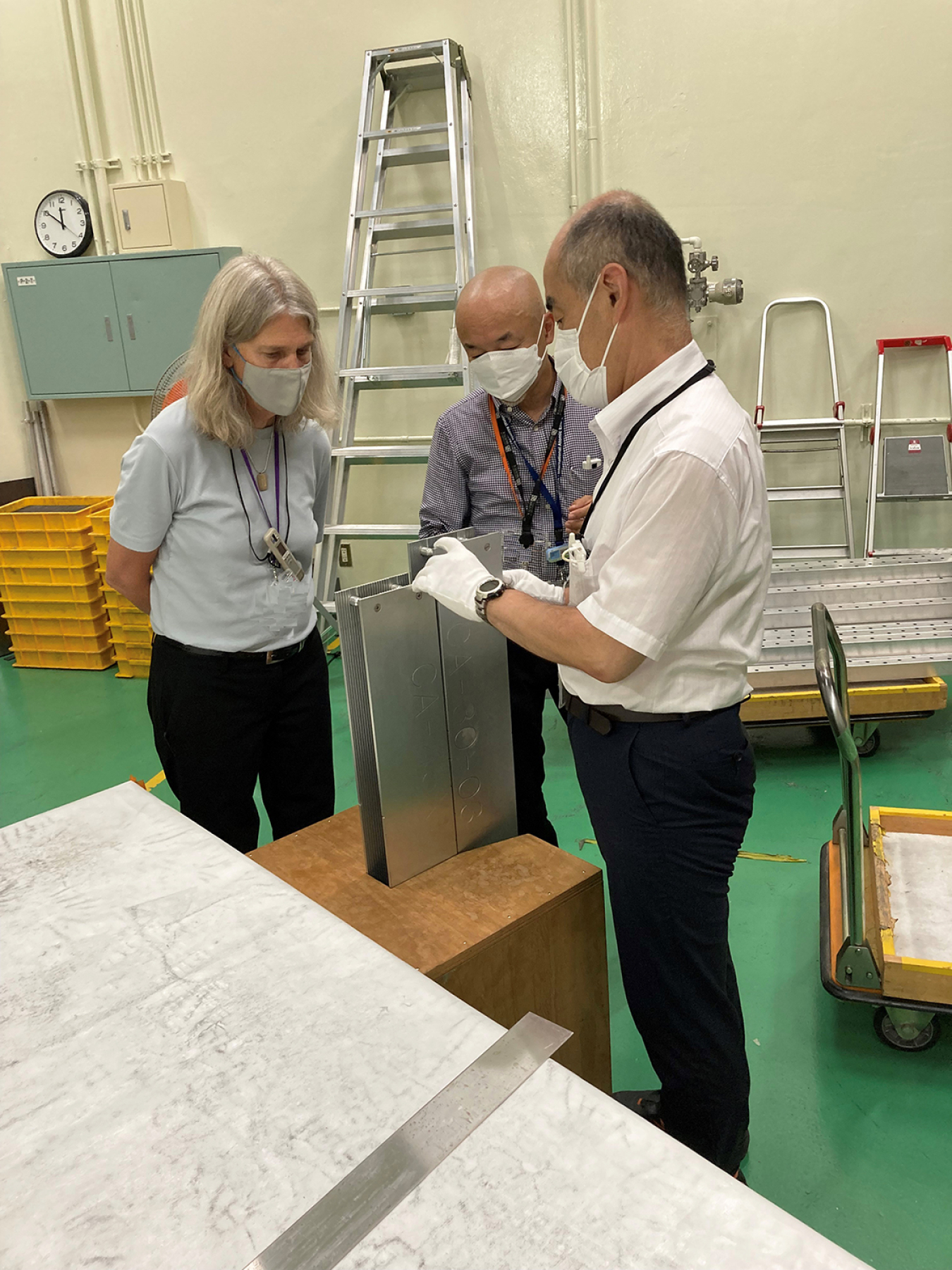 NNSA Administrator Hruby examines a mock-up of a KUCA fuel assembly with Hironobu Unesaki, left, and Tsuyoshi Misawa, professors at Kyoto University.