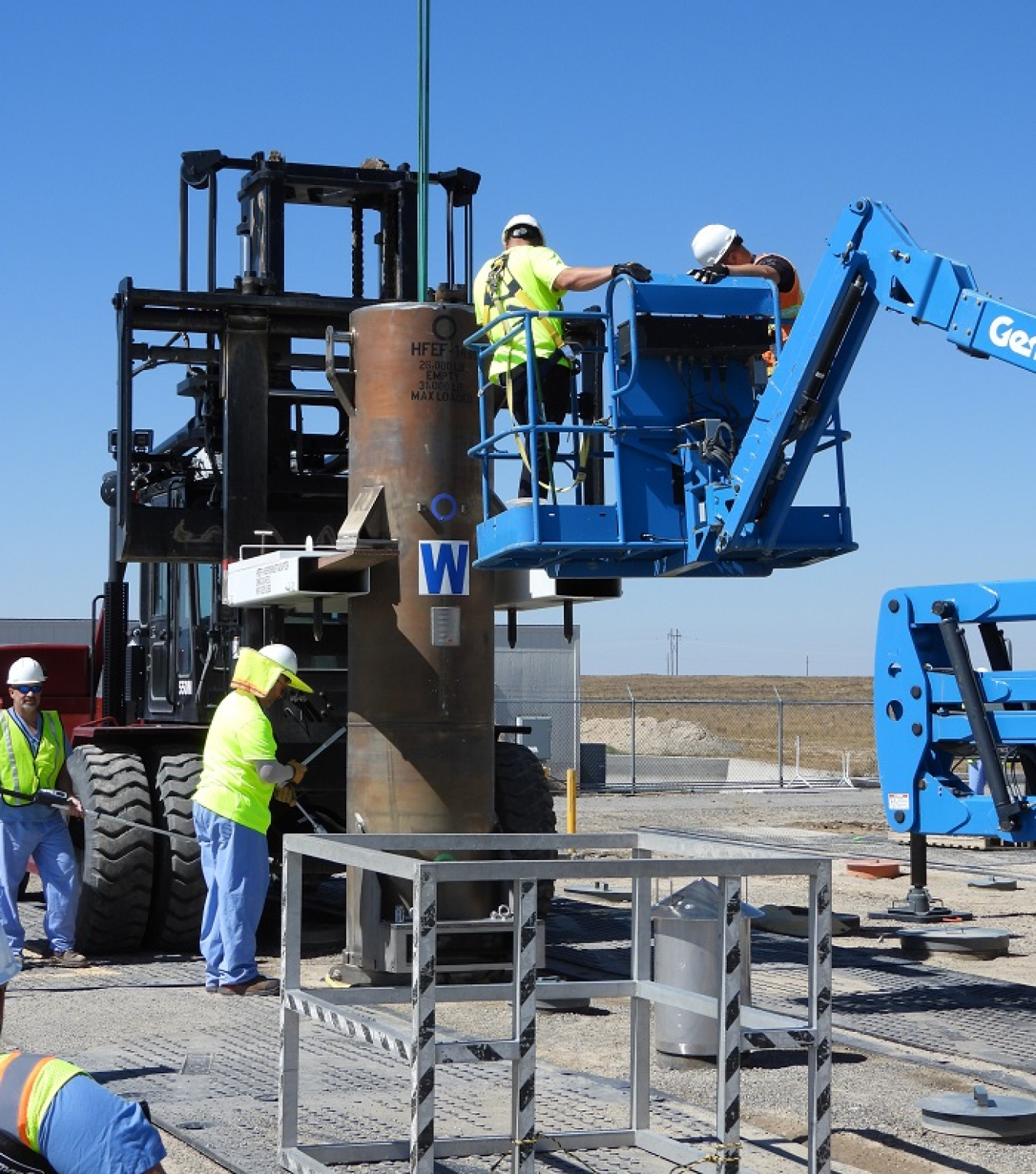 EM crews deposit the 100th shipment of Experimental Breeder Reactor-II spent nuclear fuel into a vault at the Radioactive and Scrap Waste Facility.