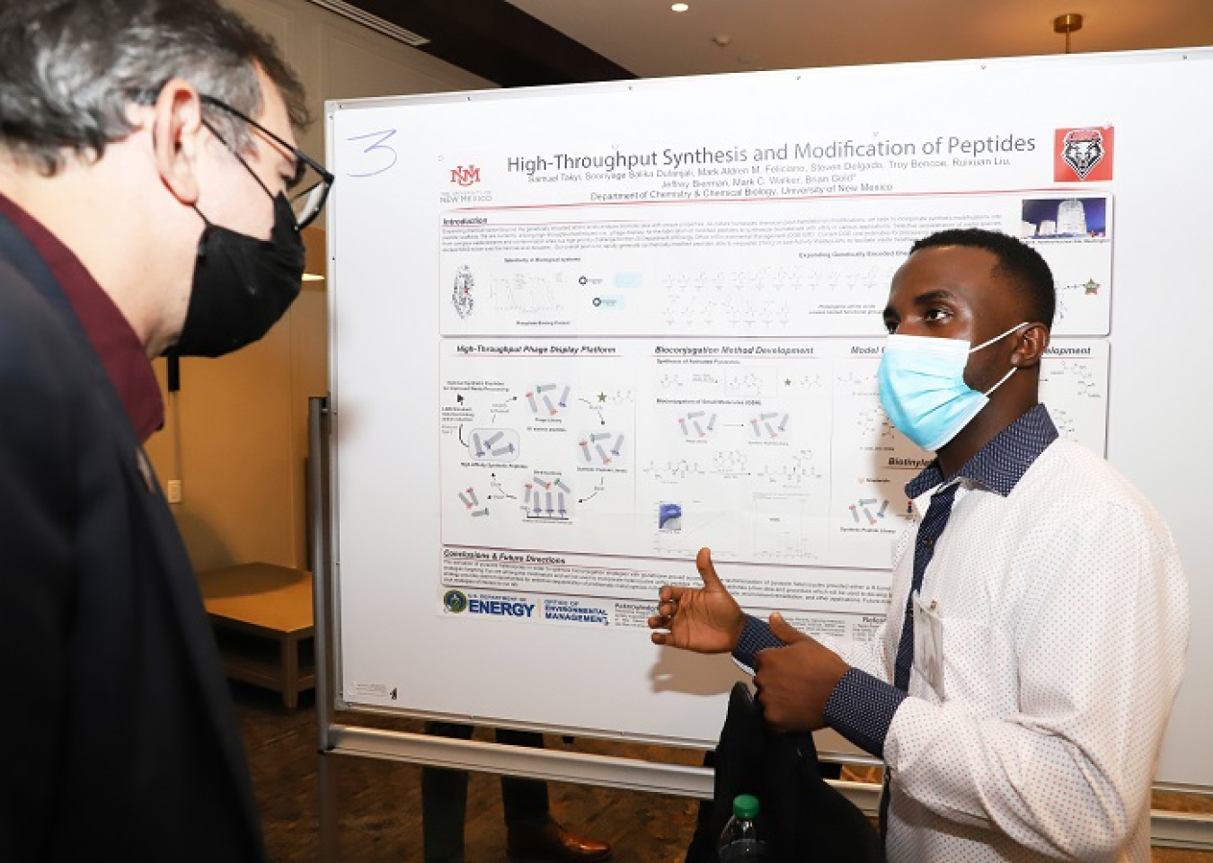 Samuel Takyi, a graduate student at the University of New Mexico Department of Chemistry and Chemical Biology, explains his research project to Konstantinos Kavallieratos, Ph.D., a professor at the Department of Chemistry and Biochemistry at Florida International University, during the poster session held Tuesday at the Minority Serving Institutions Partnership Program Competitive Research Awards Workshop.