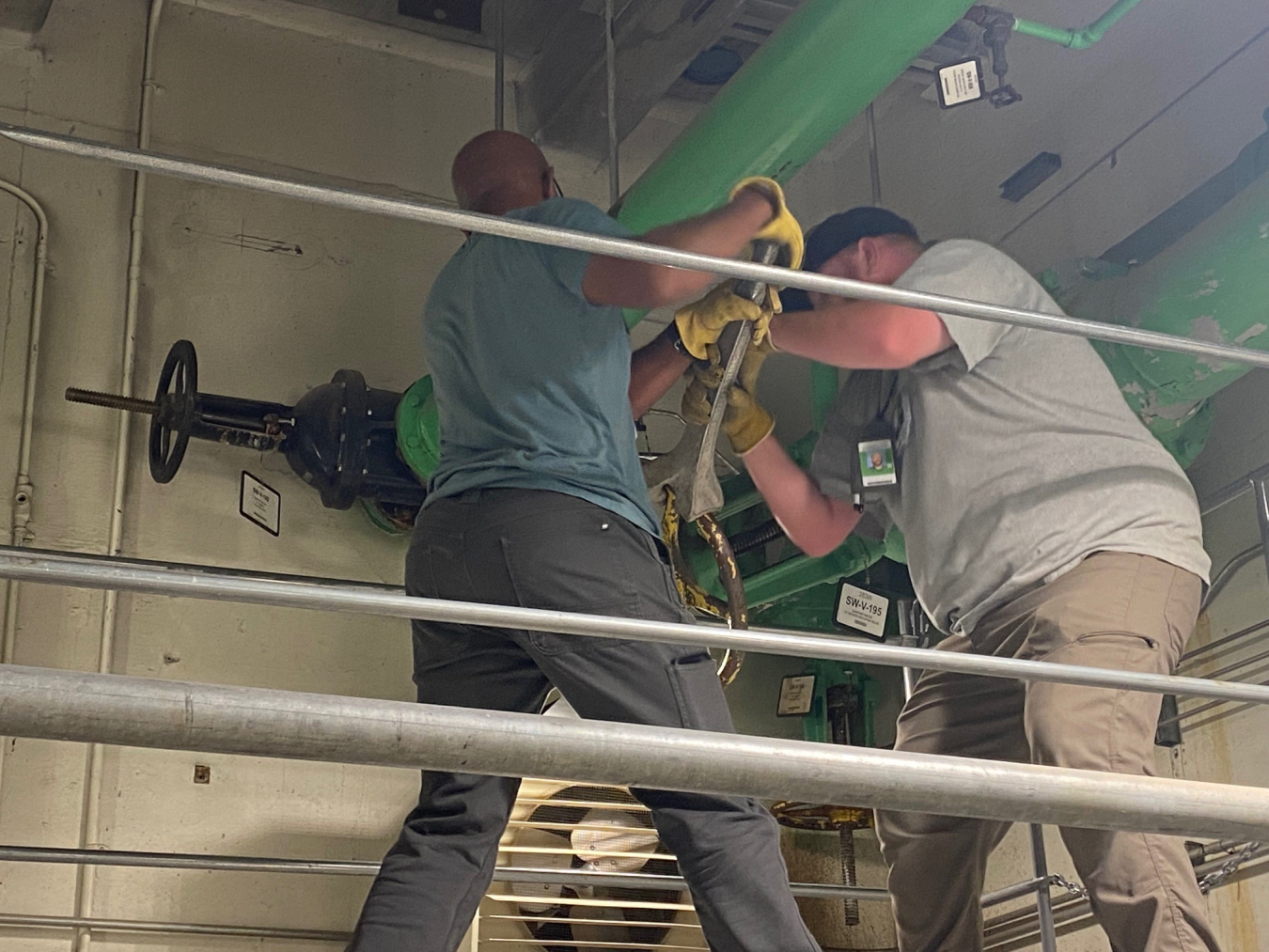 Hanford Mission Integration Solutions staff members Kyle Tilley, left, and Frank Ellis isolate water pipes on the Hanford Site.