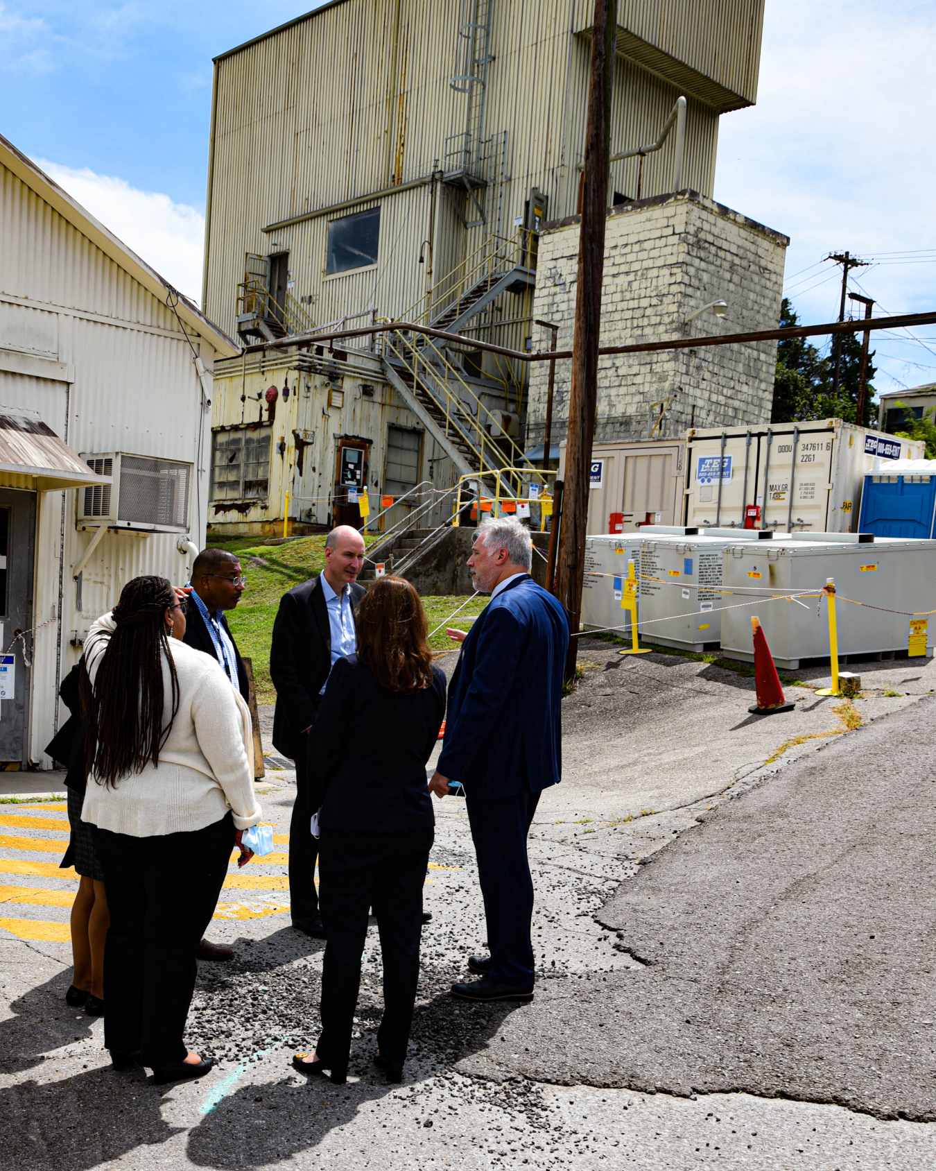 Deputy Energy Secretary David Turk, center, tours an area at Oak Ridge National Laboratory that EM will transform through the demolition of former research reactors in coming months. EM will begin the teardown of the Low Intensity Test Reactor, shown here behind Turk, before the end of the year.