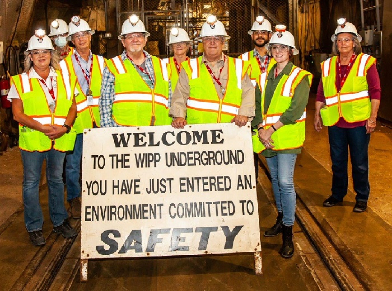 Participants in a tour of the Waste Isolation Pilot Plant (WIPP) gather upon arrival 2,150 feet beneath the surface in the WIPP underground.