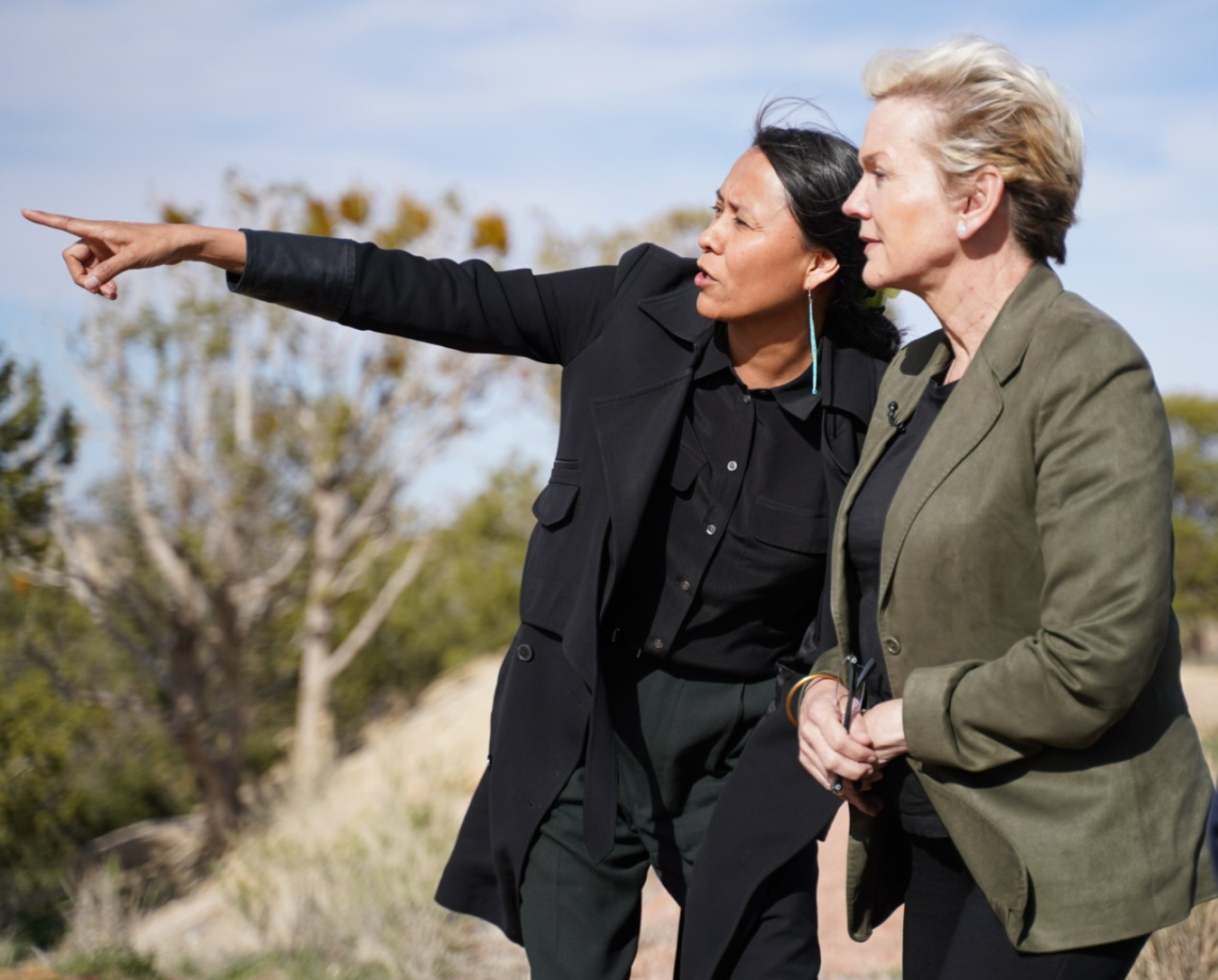 Wahleah Johns pointing into the distance to a woman beside her.