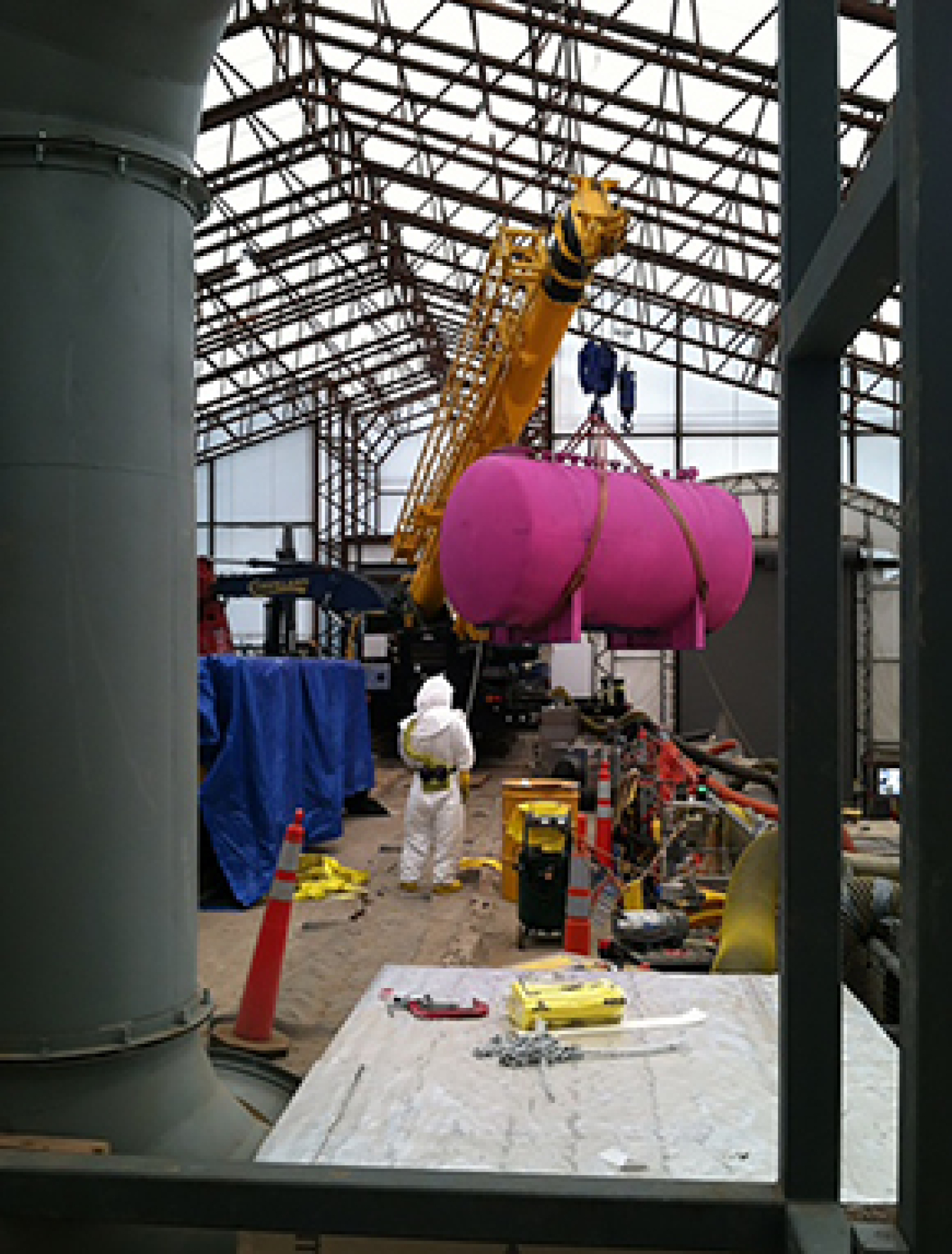 Workers prepare the last of seven waste storage tanks from a tank vault for shipment to an offsite disposal facility. The tank is prepared for transport to the disposal facility.