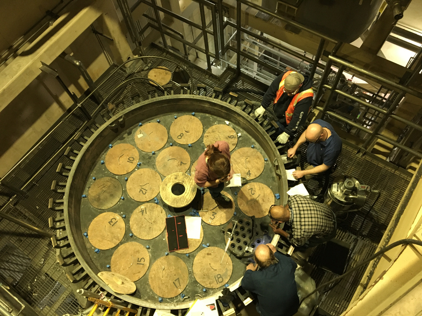 Personnel perform measurements to ensure correct seating of a process gas filter bundle prior to the start of a recently completed confirmatory run of the Integrated Waste Treatment Unit at the DOE Idaho National Laboratory Site.