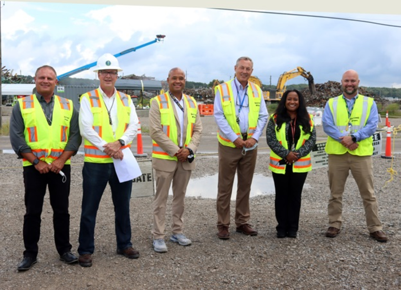 EM Office of Field Operations and Portsmouth/Paducah Project Office (PPPO) officials pose in front of the recently completed X-326 demolition at the Portsmouth Site.