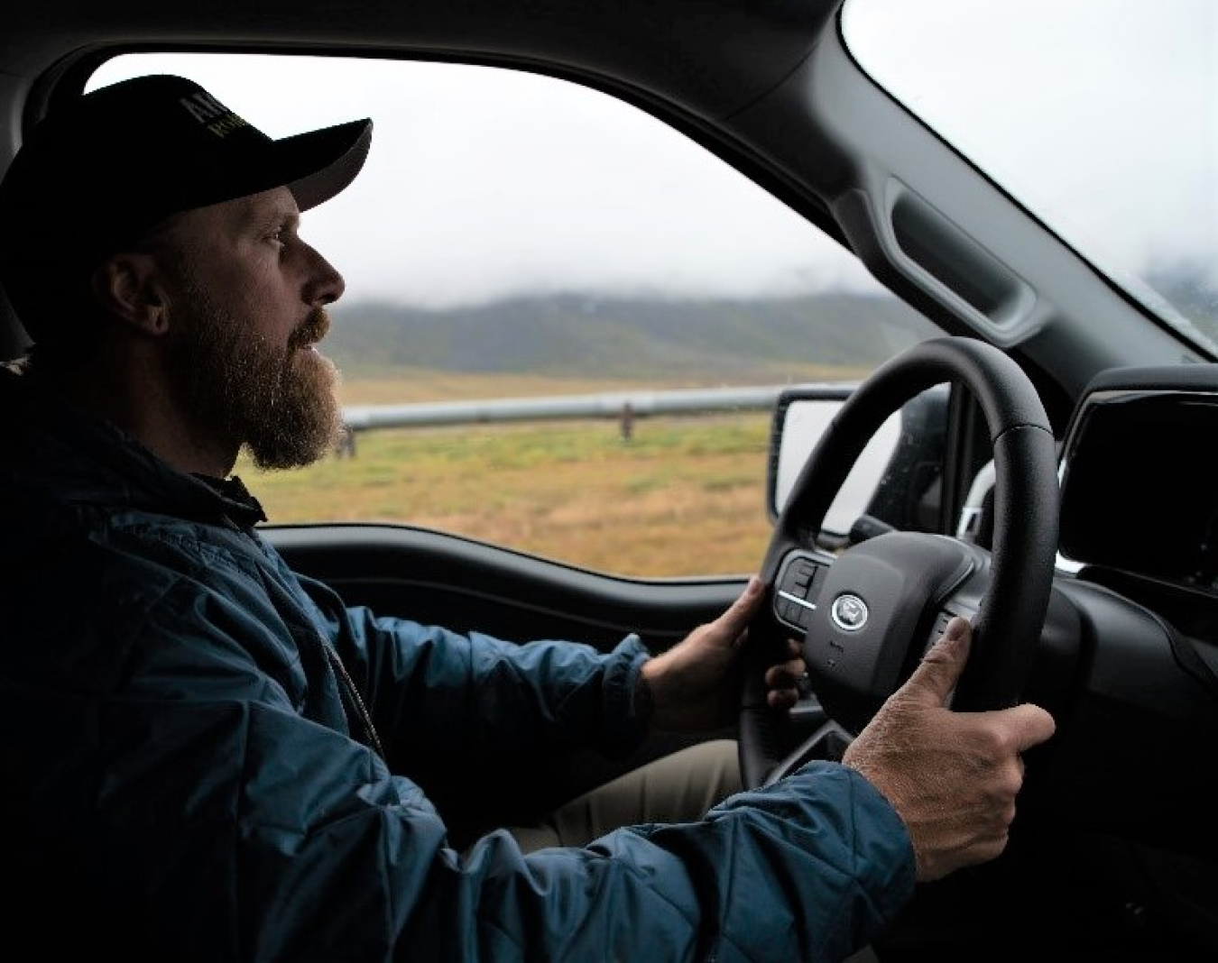 A profile of Rob Roys driving an EV vehicle along the Dalton Highway during the Arctic Road Rally. 