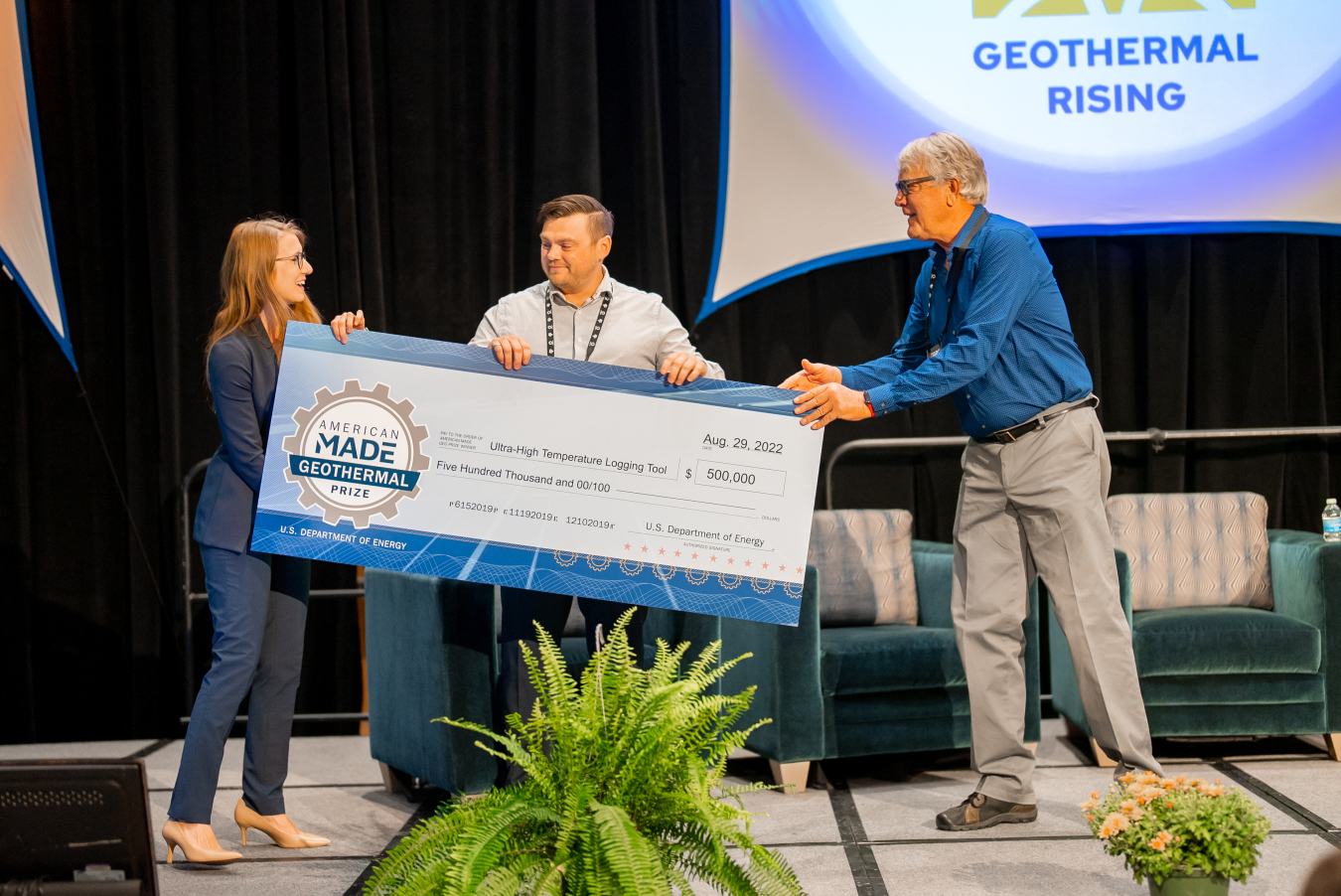 One of the winners receiving a large check.