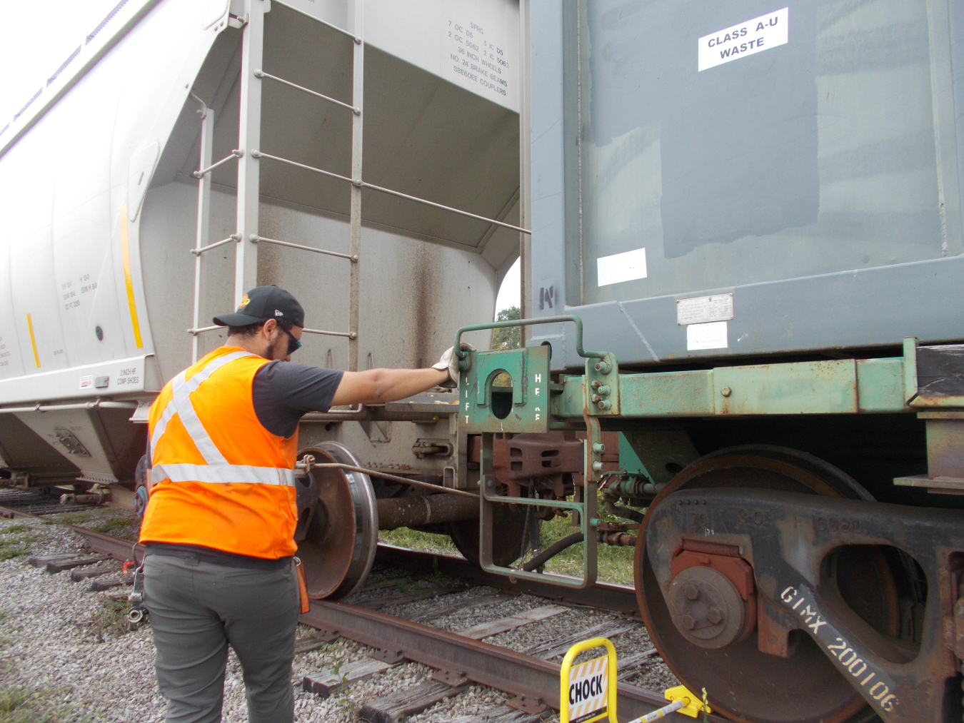 A railroad engineer prepares a shipment of demolition waste from the West Valley Demonstration Project prior to it leaving the site en route to a disposal facility. 
