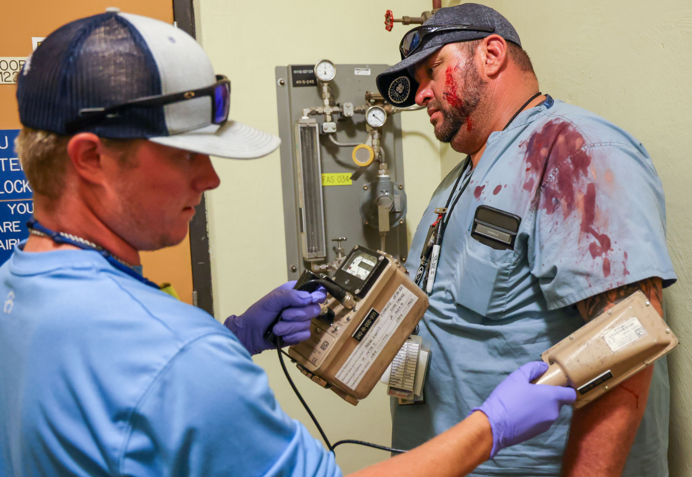 Radiological control technician Logan Norwood checks bloodied mock victim Derrick Jameson, a waste handler, for contamination following a simulated accident during the Waste Isolation Pilot Plant’s annual emergency exercise last month.