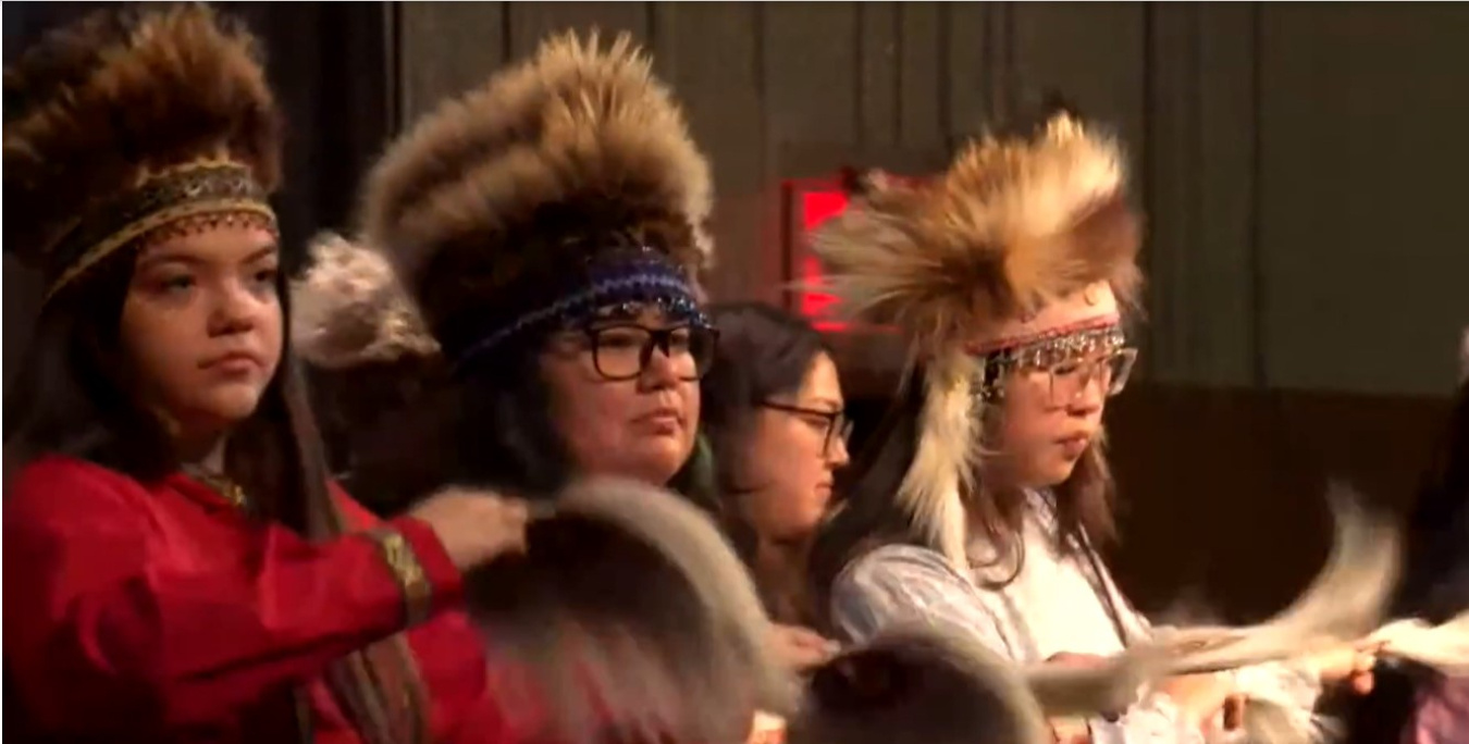 Alaska Native Heritage dancers perform on stage. 