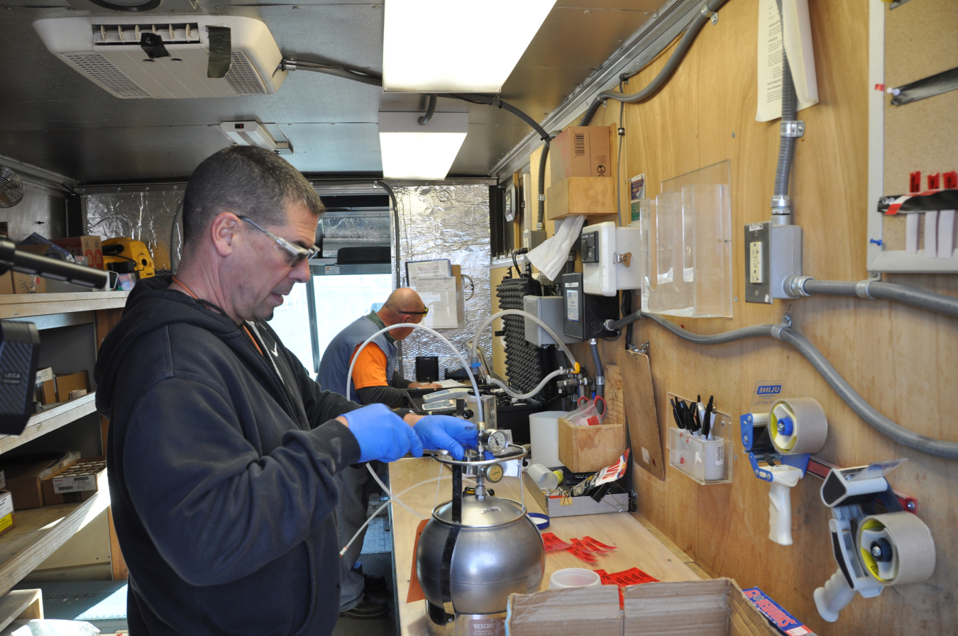 Malcom Chunn with EM Richland Operations Office contractor Central Plateau Cleanup Company’s field sampling group collects and packages a sample for testing at the 200 West Pump and Treat Facility on the Hanford Site.