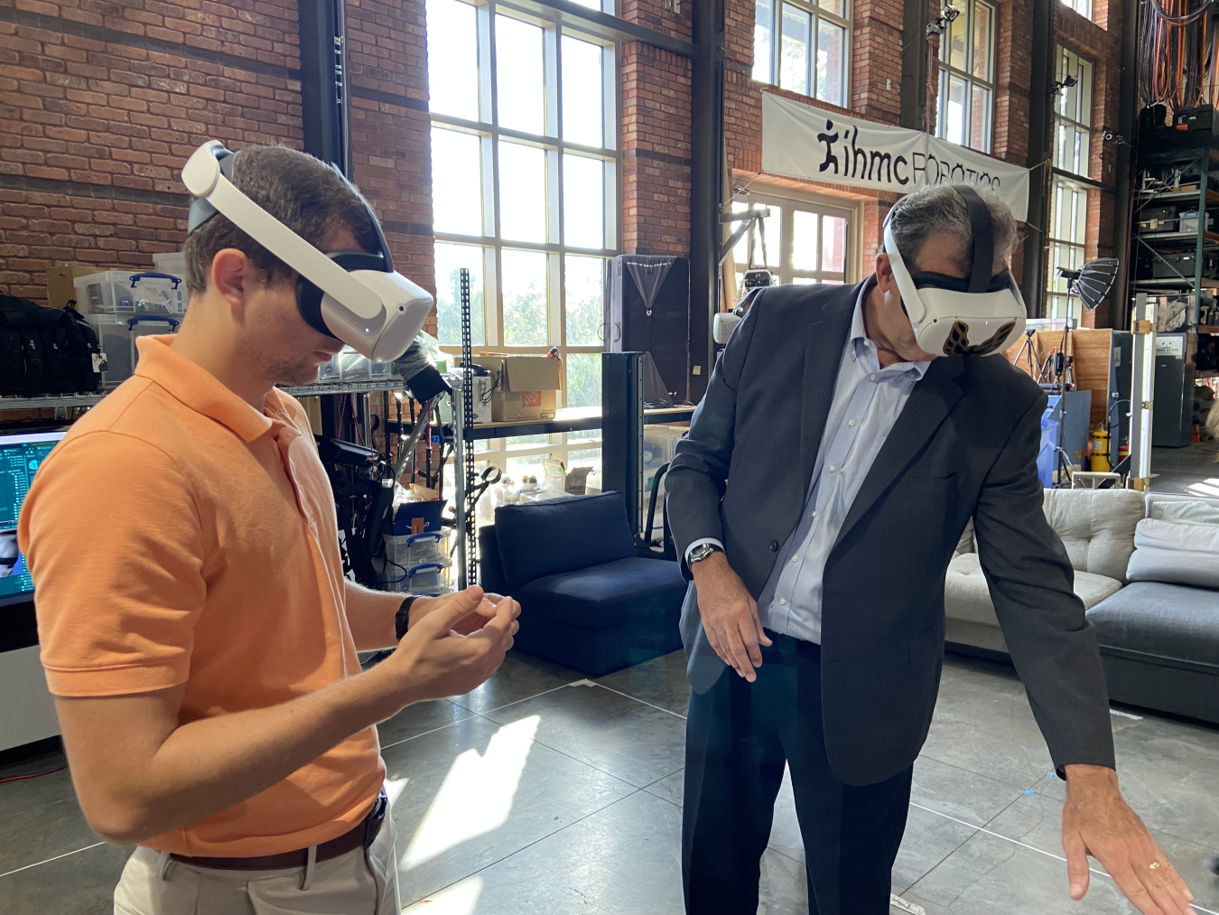 Nicholas Spivey, left, a mechanical engineer with Instrumentation, Robotics, and Imaging Systems at Savannah River National Laboratory, and Kurt Gerdes, director of EM’s Office of Technology Development, use virtual reality simulation of an EM worksite during meetings held at the Florida Institute for Human and Machine Cognition in Pensacola.