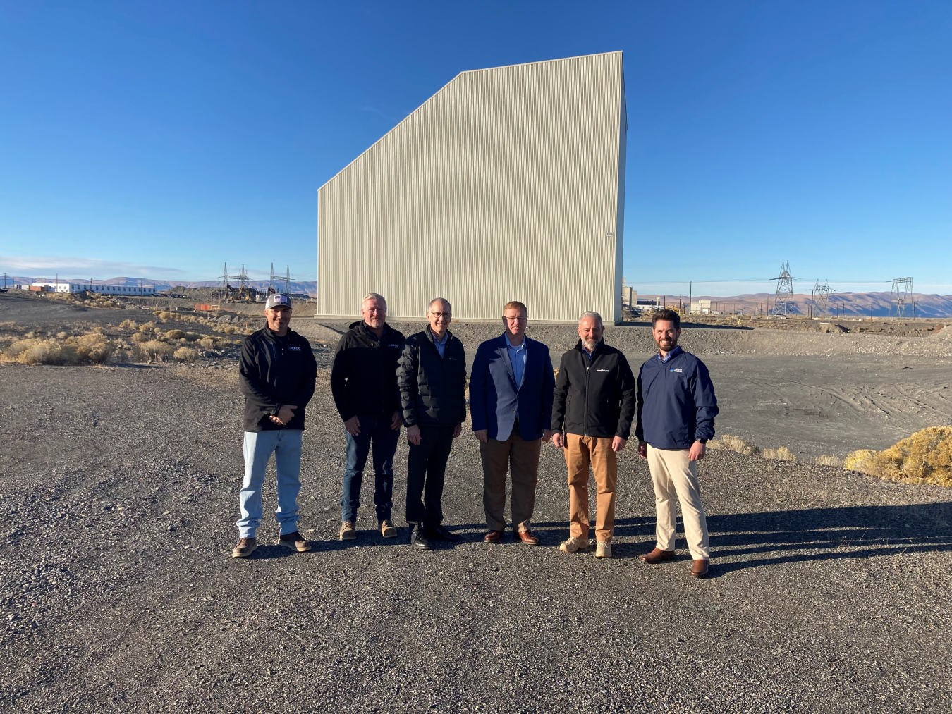 Hanford Site officials are pictured at a media event last week marking the completion of construction of a protective enclosure around the K East Reactor building.