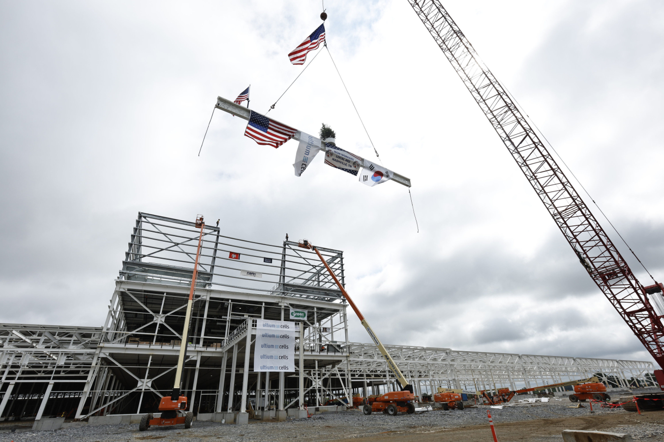 Ironworkers and construction partners at the Ultium Cells battery cell manufacturing facility install the final beam as part of a traditional “topping out” ceremony