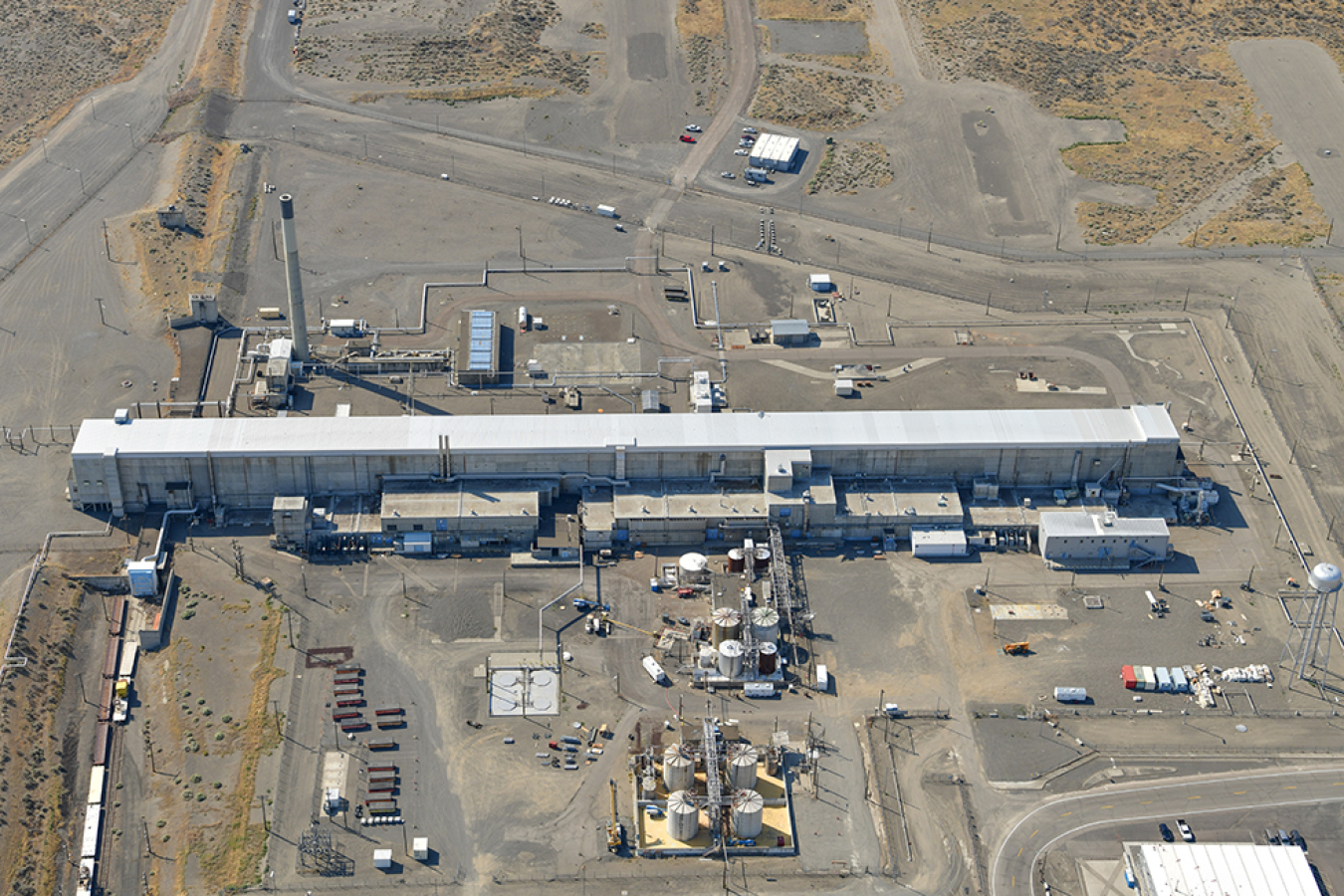 An aerial view of the Plutonium Uranium Extraction Plant. The main facility is at center. Also shown is the 211-A Chemical Storage Area, which is the open area just below the main facility, and the 203-A Acid Storage Area, which is the open area in foreground. 