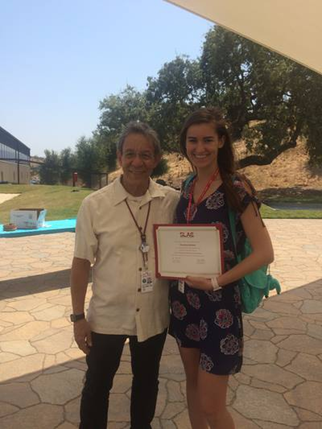 Anastasiya Stasyuk holding a certificate standing with a man.