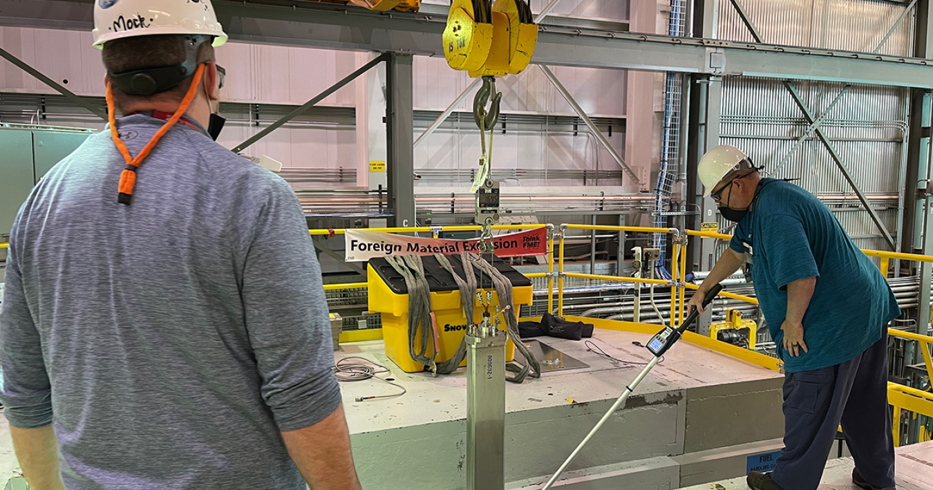Researchers load in testing device to TREAT