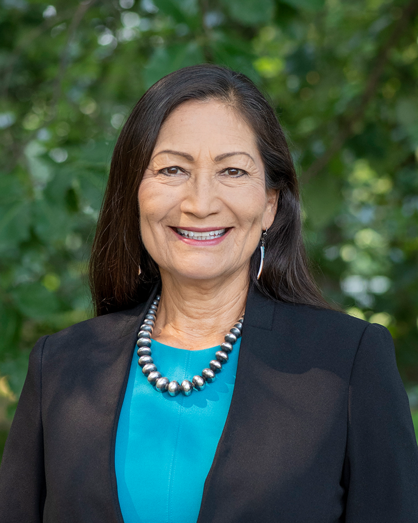 Deb Haaland smiles at the camera.