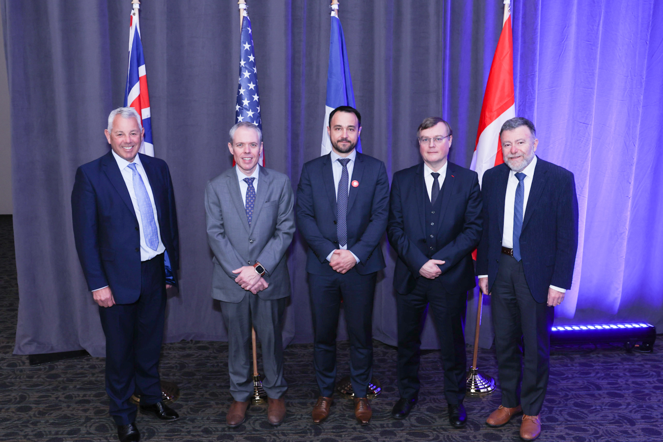 Five International leaders pose for a group photo.