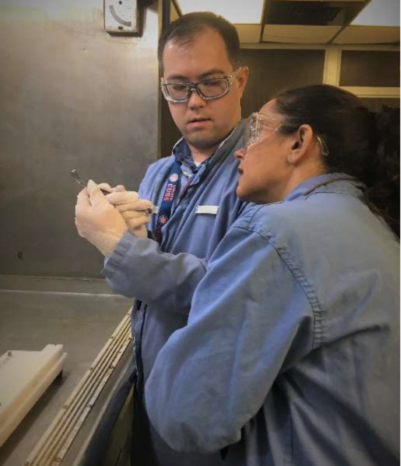 Kathryn Metzger and Jeff Leong inspect pellets