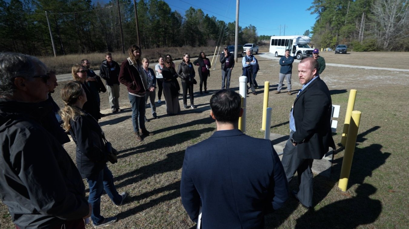Tom Danielson, right, a scientist in the Environmental Science and Dosimetry Division of the Environmental Management Directorate at Savannah River National Laboratory, leads a field discussion about the groundwater sensor network installed at Savannah River Site’s F Area as part of the Advanced Long-Term Environmental Monitoring System project. (Image by Brad Bohr)
