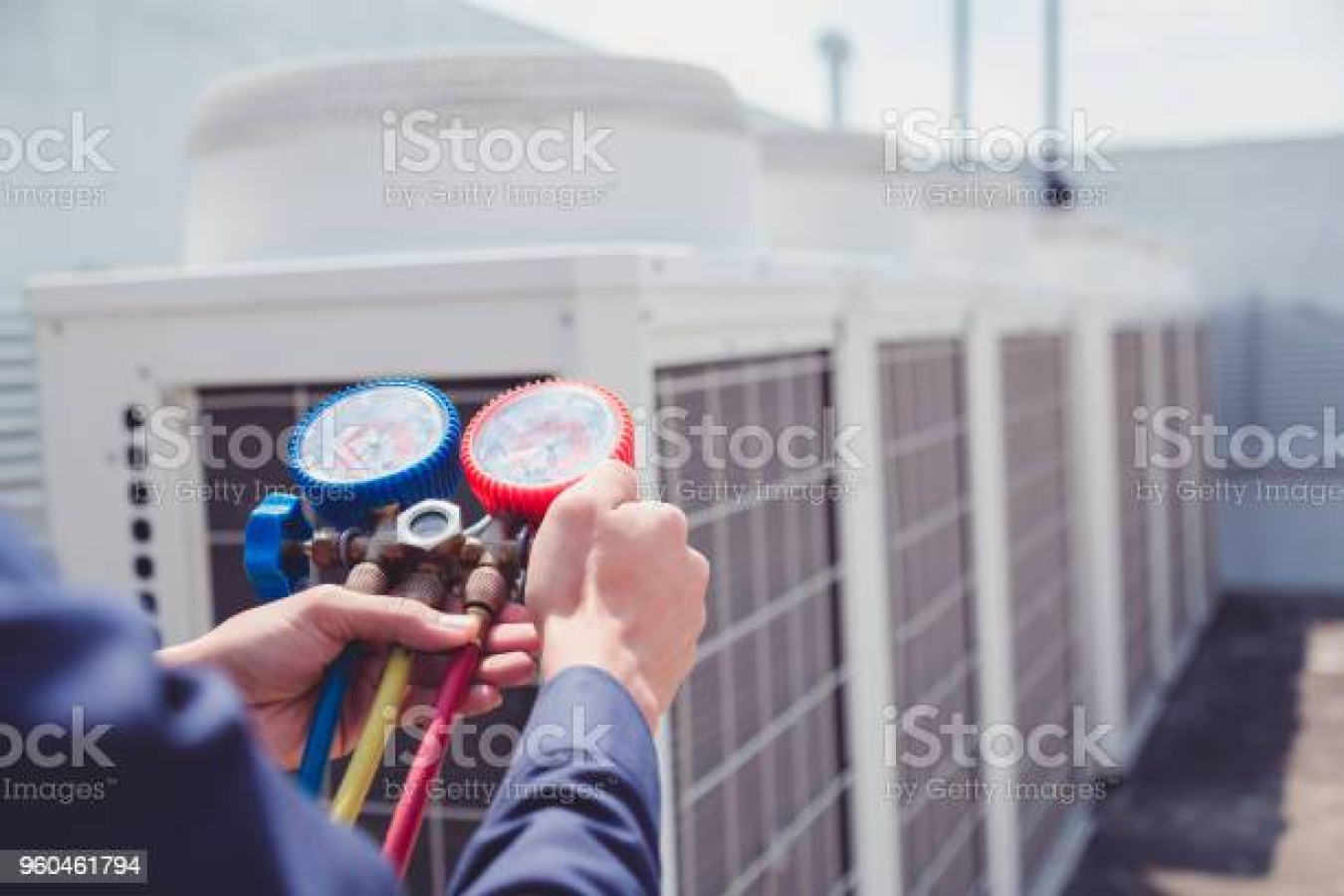 Technician is checking air conditioner ,measuring equipment for filling air conditioners