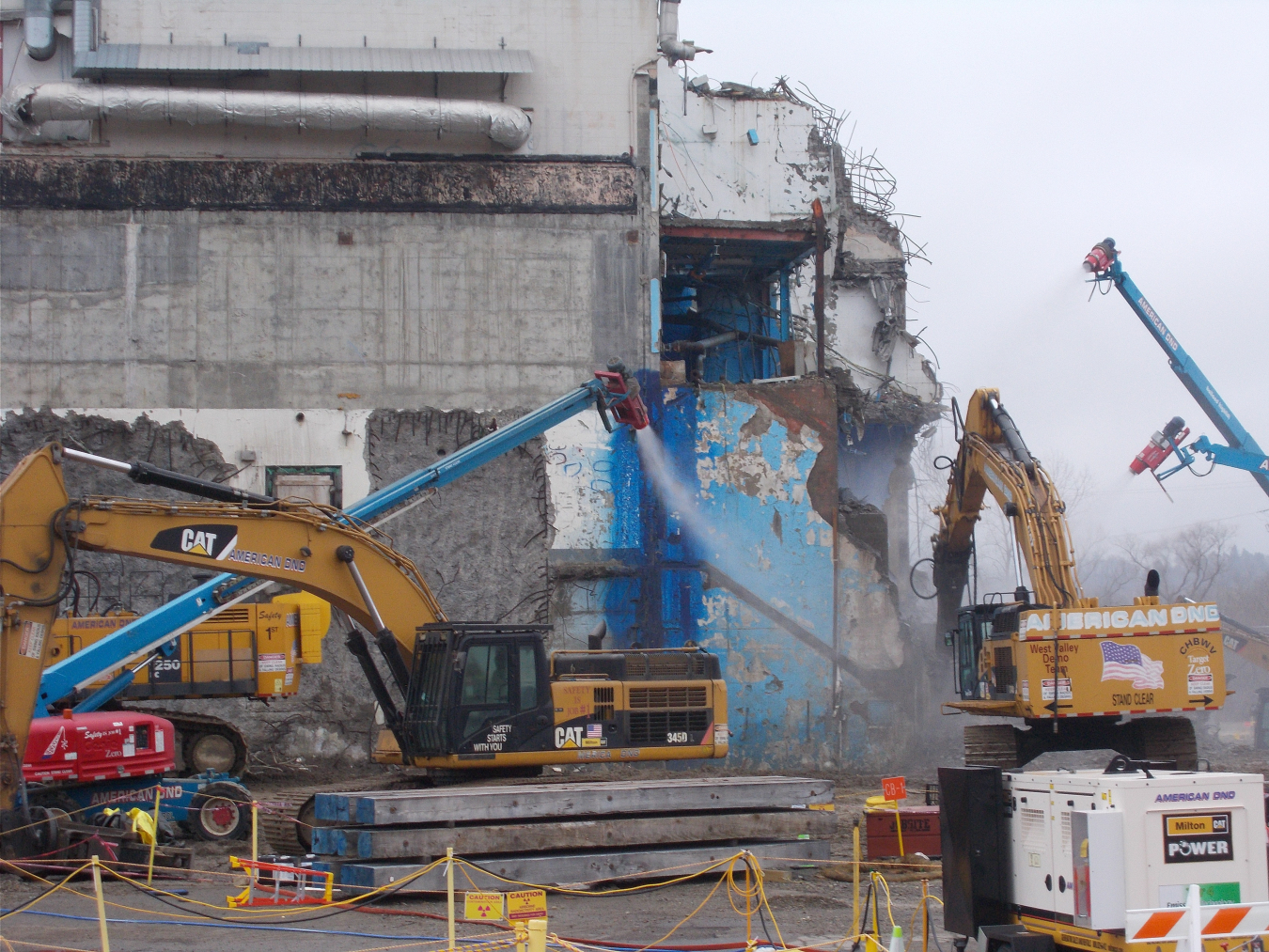 An operator uses an excavator with a hydraulic hammer to deconstruct the Acid Recovery Cell to prepare for the removal of reinforced-concrete floor blocks as part of the deconstruction of the Main Plant Process Building at EM's West Valley Demonstration Project. 