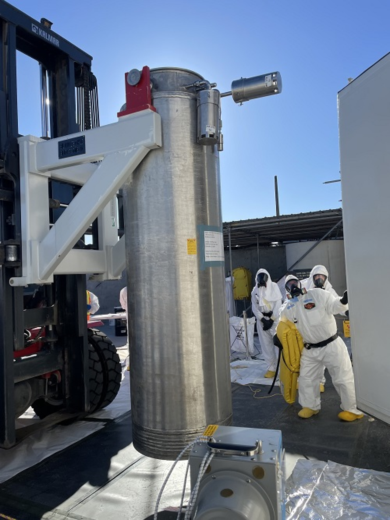 During a planned maintenance outage, workers change out spent 27,000-pound filter columns in the Tank-Side Cesium Removal System and place them on a nearby storage pad.