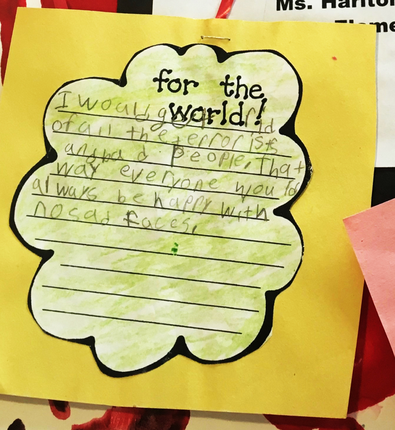 A child's handwritten response on a colored-paper school school assignment with the prompt "for the world" written on it.