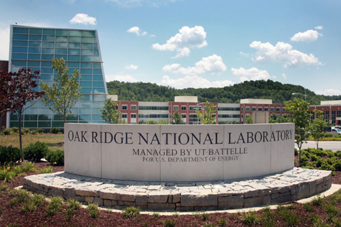 Sign in front of the facility that reads; Oak Ridge National Laboratory - Managed by UT Battelle - For U.S. Department of Energy