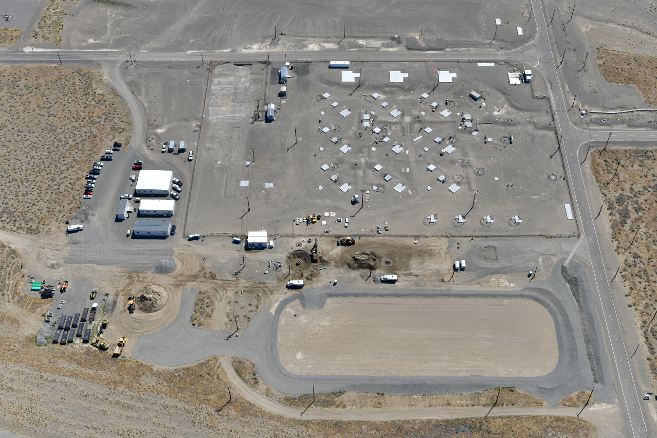 An aerial view of U Tank Farm on the Hanford Site shows the completed evapotranspiration basin next to the tank farm. The basin will collect rainwater and snowmelt that runs off an interim surface barrier that Fowler General Construction will install this year. 