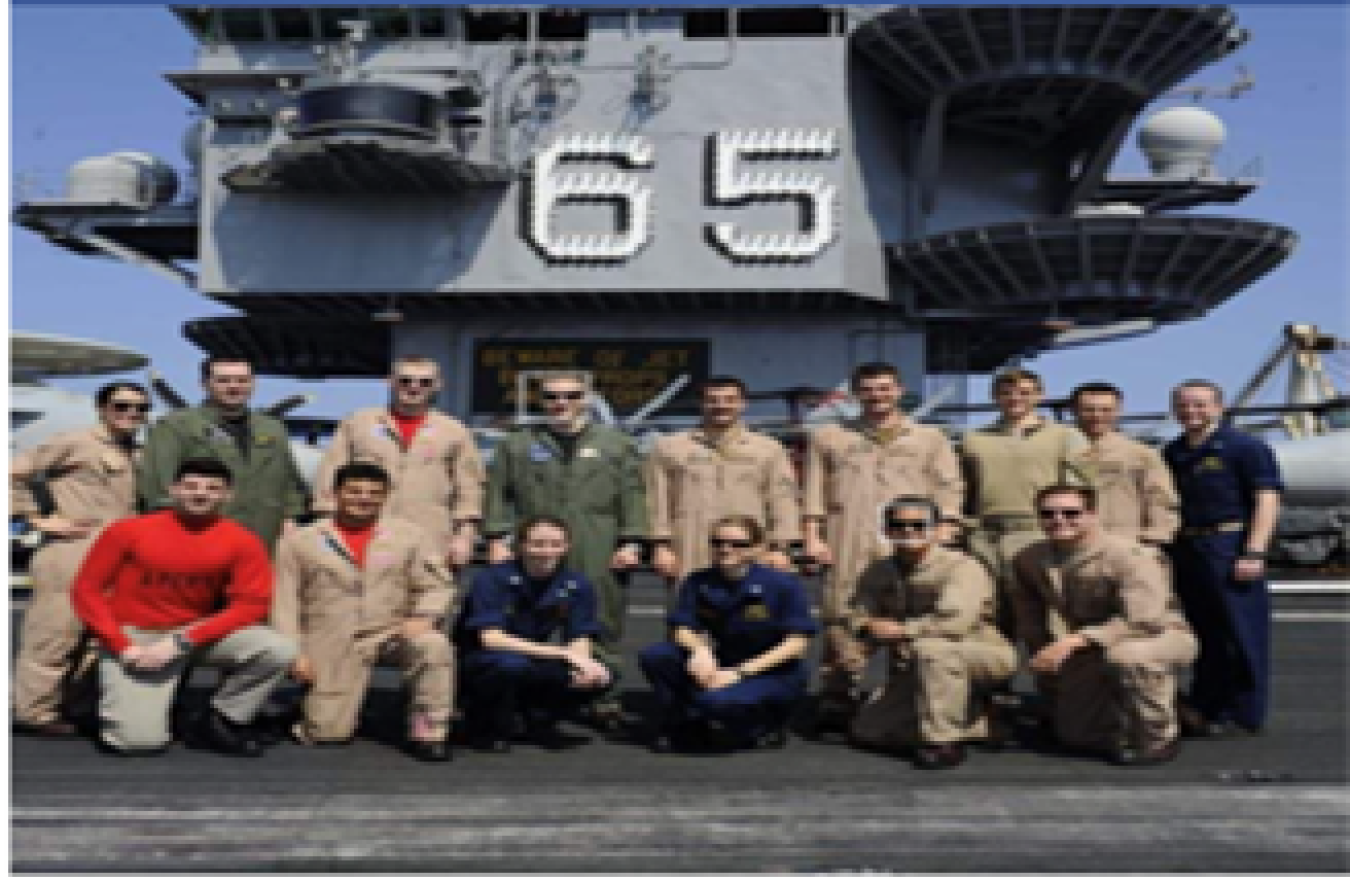 Sarah Mustin pictured with crew on a naval ship