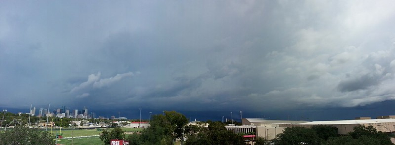 Photo of the skyline of Houston, Texas with dark clouds above it